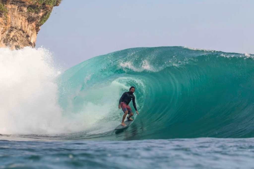 adin surf coach surfing in a wave barrel